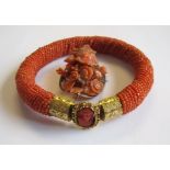 A Coral Bracelet constructed from small beads with gilt metal clasp set carved oval cameo and a