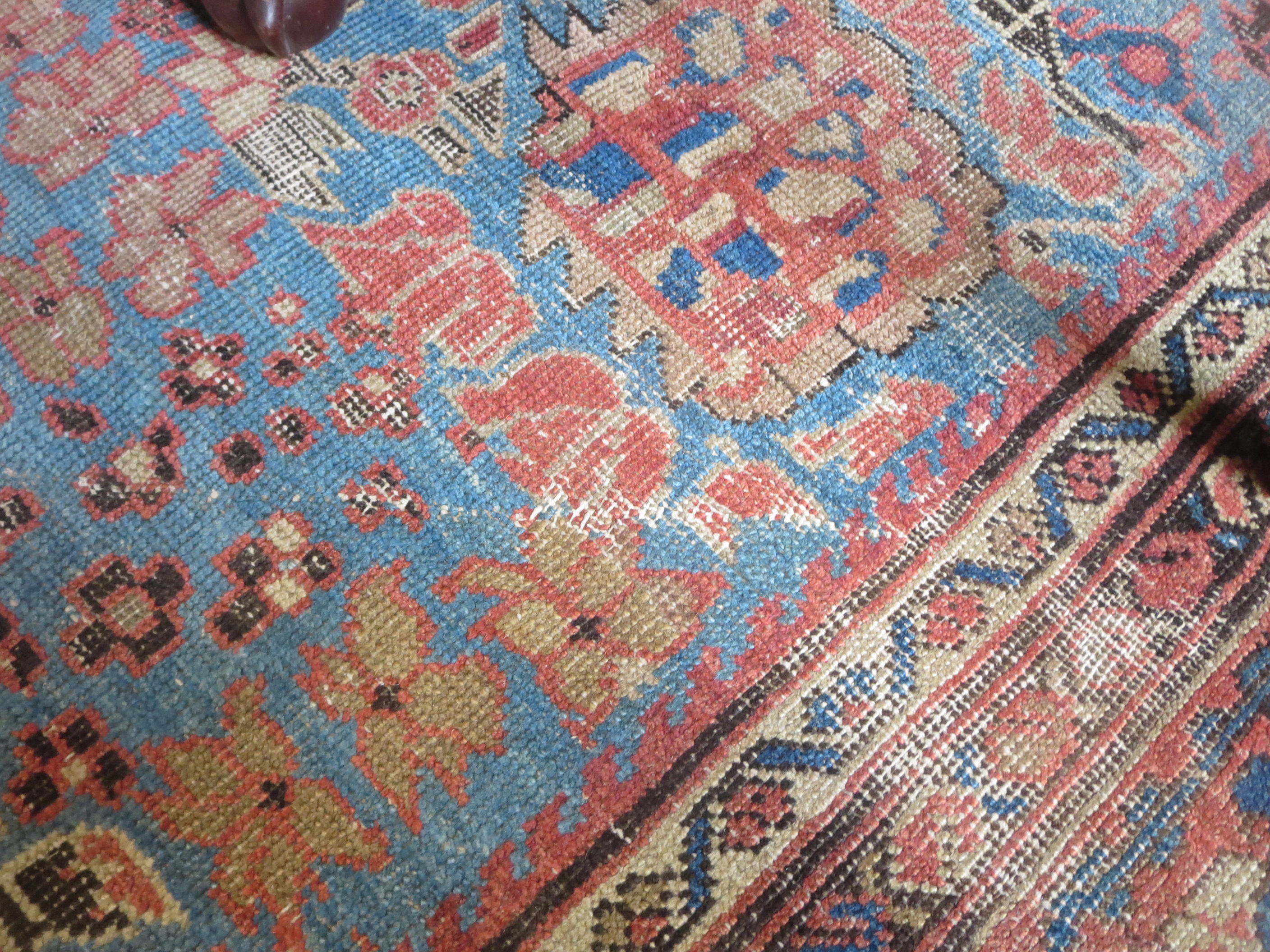 An old bordered Persian Carpet with red stylised motifs on a blue ground, principal border with - Image 7 of 8