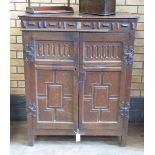 A 19th Century oak Cupboard fitted a pair of panelled doors below a frieze of applied mouldings with