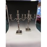 A pair of plated four branch, five light Candelabra on square bases, 22in