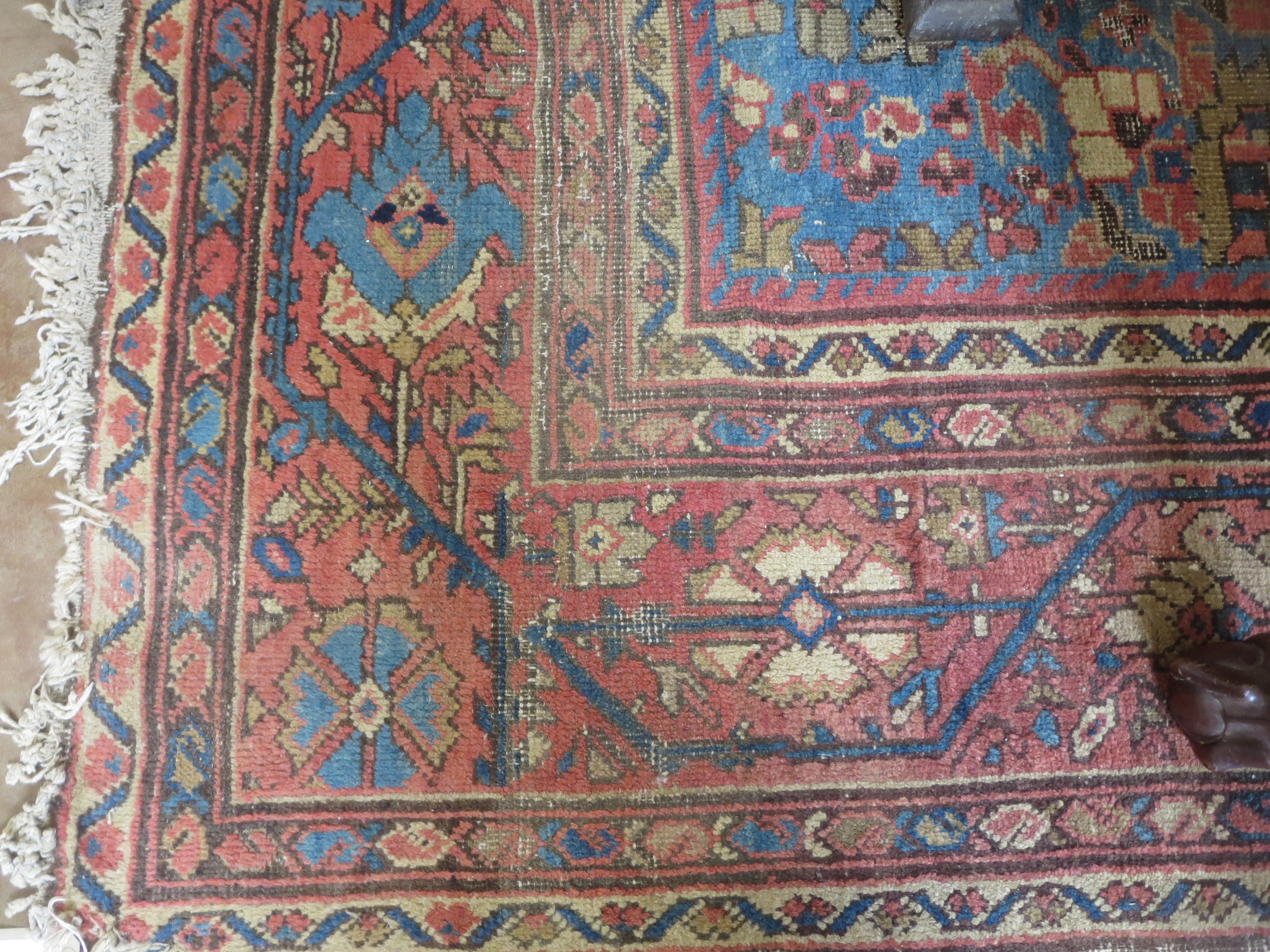 An old bordered Persian Carpet with red stylised motifs on a blue ground, principal border with - Image 5 of 8