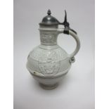 A 16th Century style German white stoneware Stein with moulded coats of arms and inscription on neck