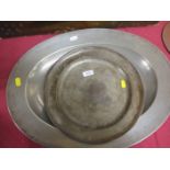 An 18th Century pewter oval Dish with broad rim, 21in and an 18th Century pewter Plate with