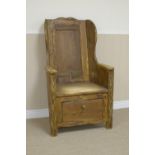 A pine Lambing Chair with panelled back, solid seat and deep drawer under