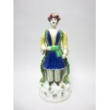 A 19th Century Staffordshire Figure of a Turk with yellow robes and painted details, 14 1/2in,