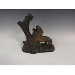 A 19th Century cast Money Box with monkey seated on tree trunk feeding a lion 9in H