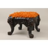 A Folk Art Footstool, the friezes carved animals with lion mask supports, 12in square