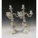 A pair of Meissen three branch Candelabra with floral and leaf designs each supported by pair of