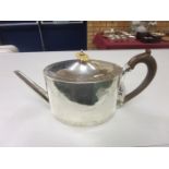 A George III silver Teapot of oval form with engraving of floral swags and having wooden handle,