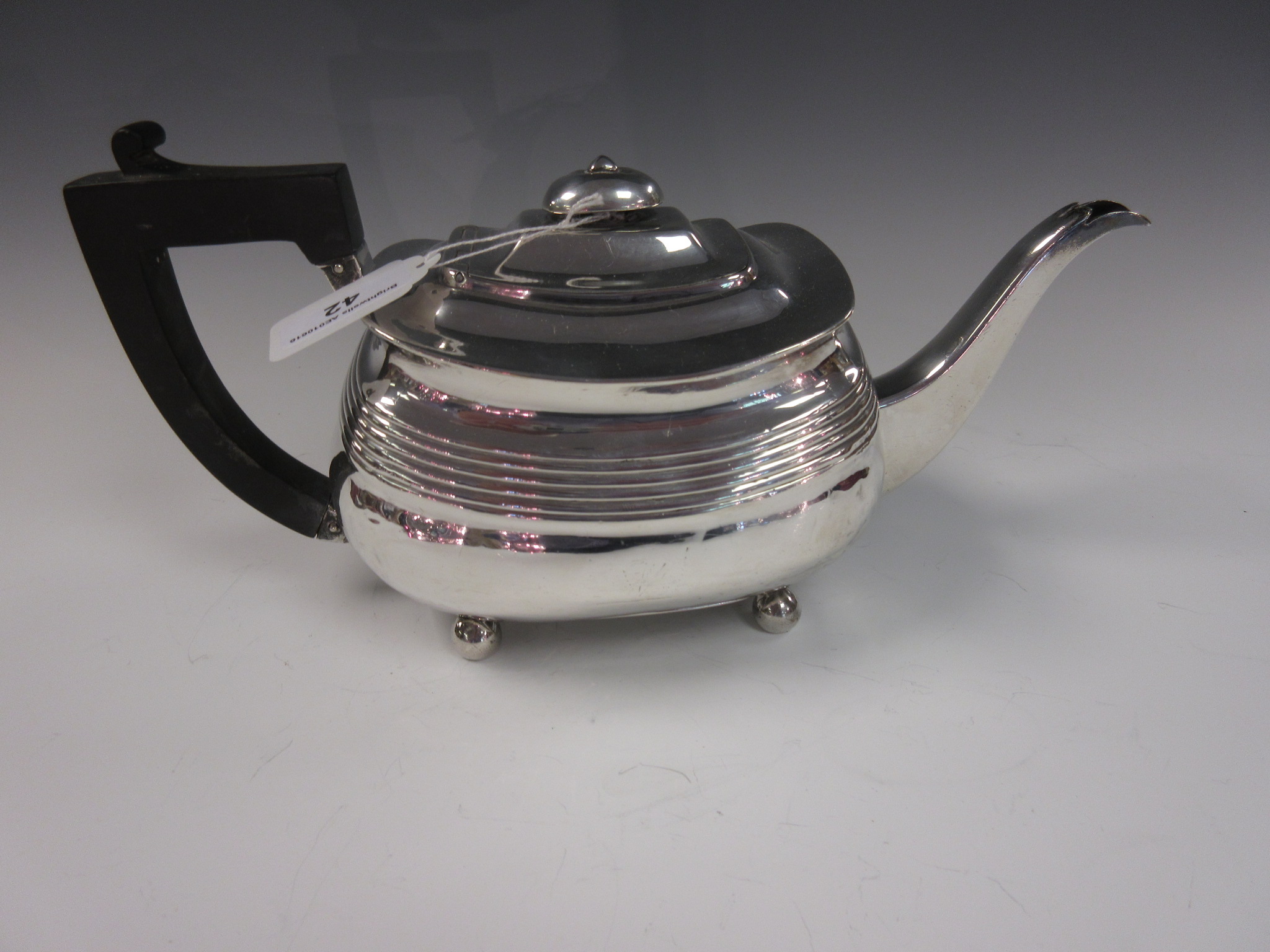 A George III silver boat shape Teapot on bun feet, London 1808