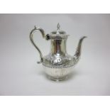 A Victorian silver semi-fluted Coffee Pot with floral scroll embossing, leafage scroll handle,