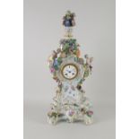 An impressive Meissen Mantel Clock with floral decoration, urn finial, applied figures, floral