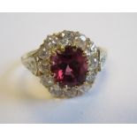 A Red Spinel and Diamond Cluster Ring claw-set mixed-cut spinel within a frame of pavé-set old-cut