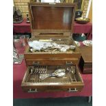 A walnut Canteen with hinged lid and two drawers containing part set of EP cutlery old english