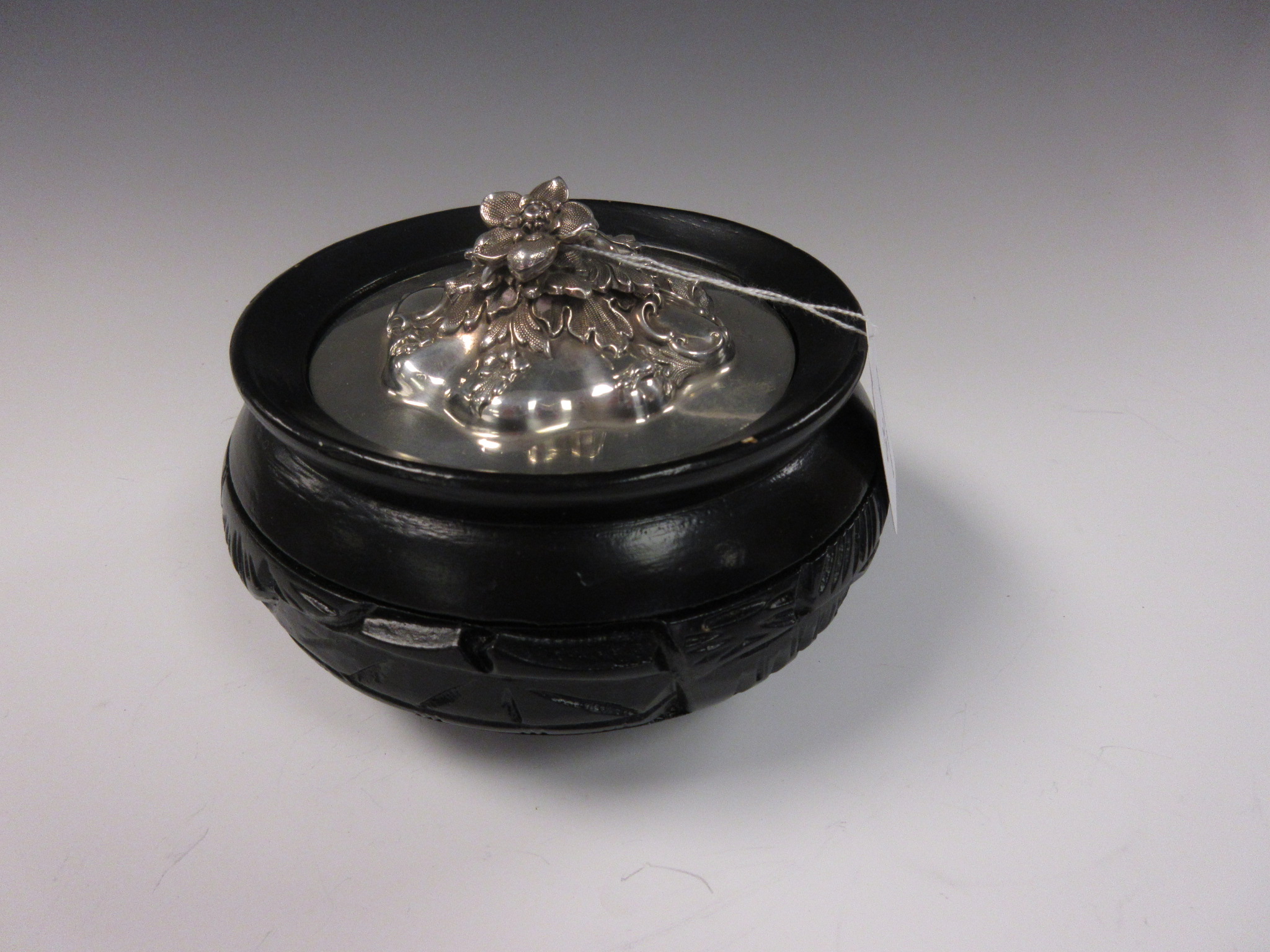 A silver covered Bowl with floral embossed finial and later ebonised base, 6in Diam