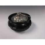 A silver covered Bowl with floral embossed finial and later ebonised base, 6in Diam