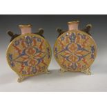 A pair of Grainger Worcester Moon Flasks, moulded scroll designs in blue, red and gold, with two