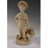 A Royal Worcester Hadley figure of standing Boy with hat, holding an oval basket, with stump