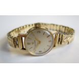 A Lady's Omega Wristwatch the silvered dial with arabic numerals and baton markers on 9ct gold