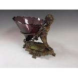 A brass Stand in the form of a Cherub with floral wreath and rope design holding amethyst glass