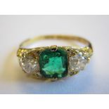 An Emerald and Diamond three stone Ring claw-set cushion-cut emerald, 0.93cts, between two old-cut