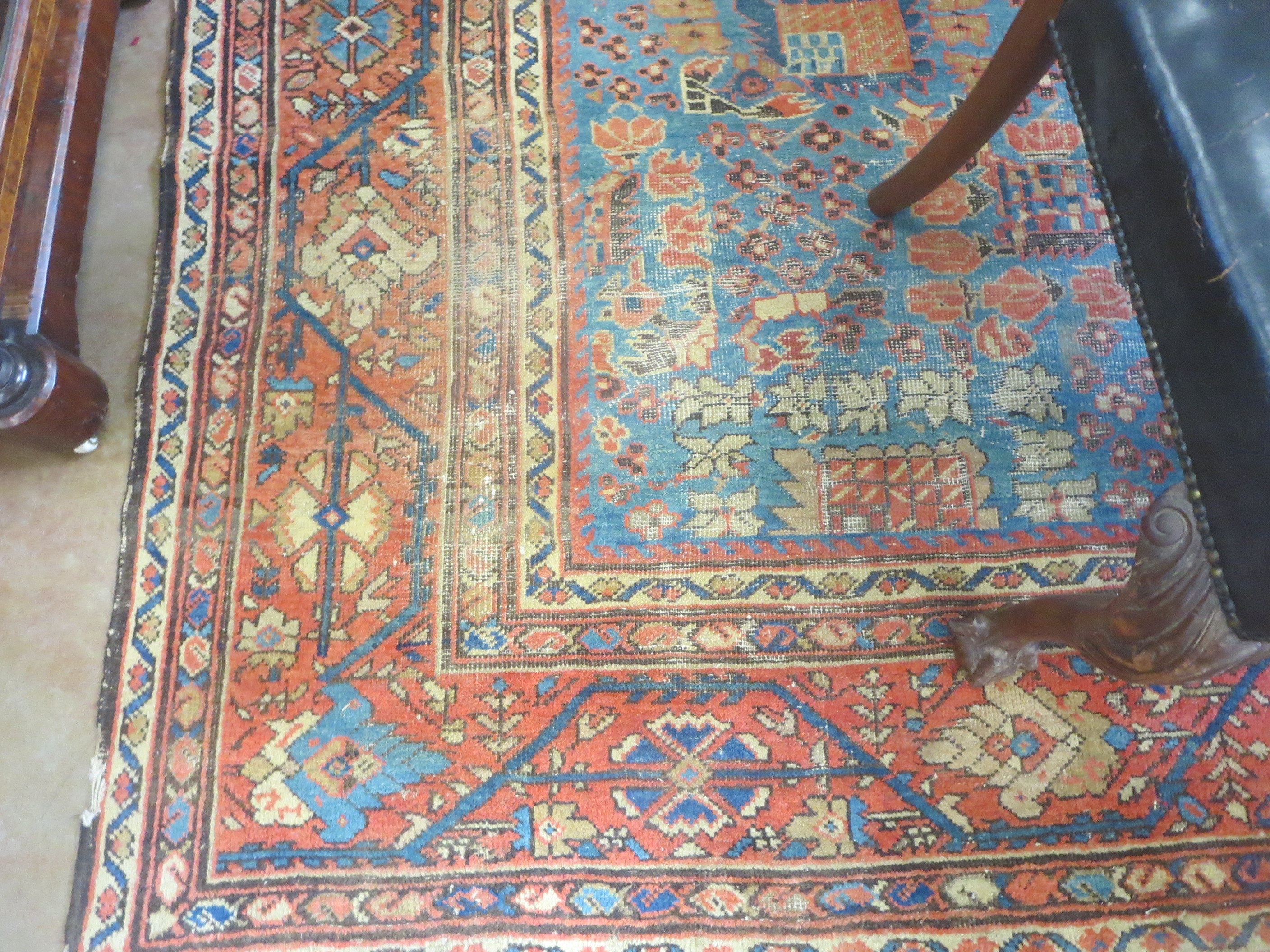 An old bordered Persian Carpet with red stylised motifs on a blue ground, principal border with - Image 2 of 8
