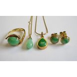 A Jade Ring claw-set oval cabochon in 14ct gold, ring size J, two Jade Drop Pendants on fine