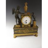 A French Mantel Clock with circular white dial, gilt metal and bronze case with urn finial, cherub