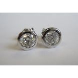 A pair of Diamond Ear Studs each with rub-over set brilliant-cut stone approx 0.75cts, in 18ct white