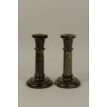 A pair of Cornish serpentine Candlesticks with cylindrical columns and stepped circular bases, 7 1/