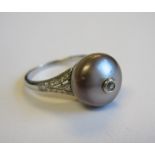 A Pearl and Diamond Ring set bouton pearl mounted small old-cut diamond with eight-cut diamonds