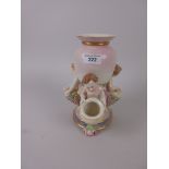 A Royal Worcester Table Centre Piece with central Vase supported by three amorini holding three
