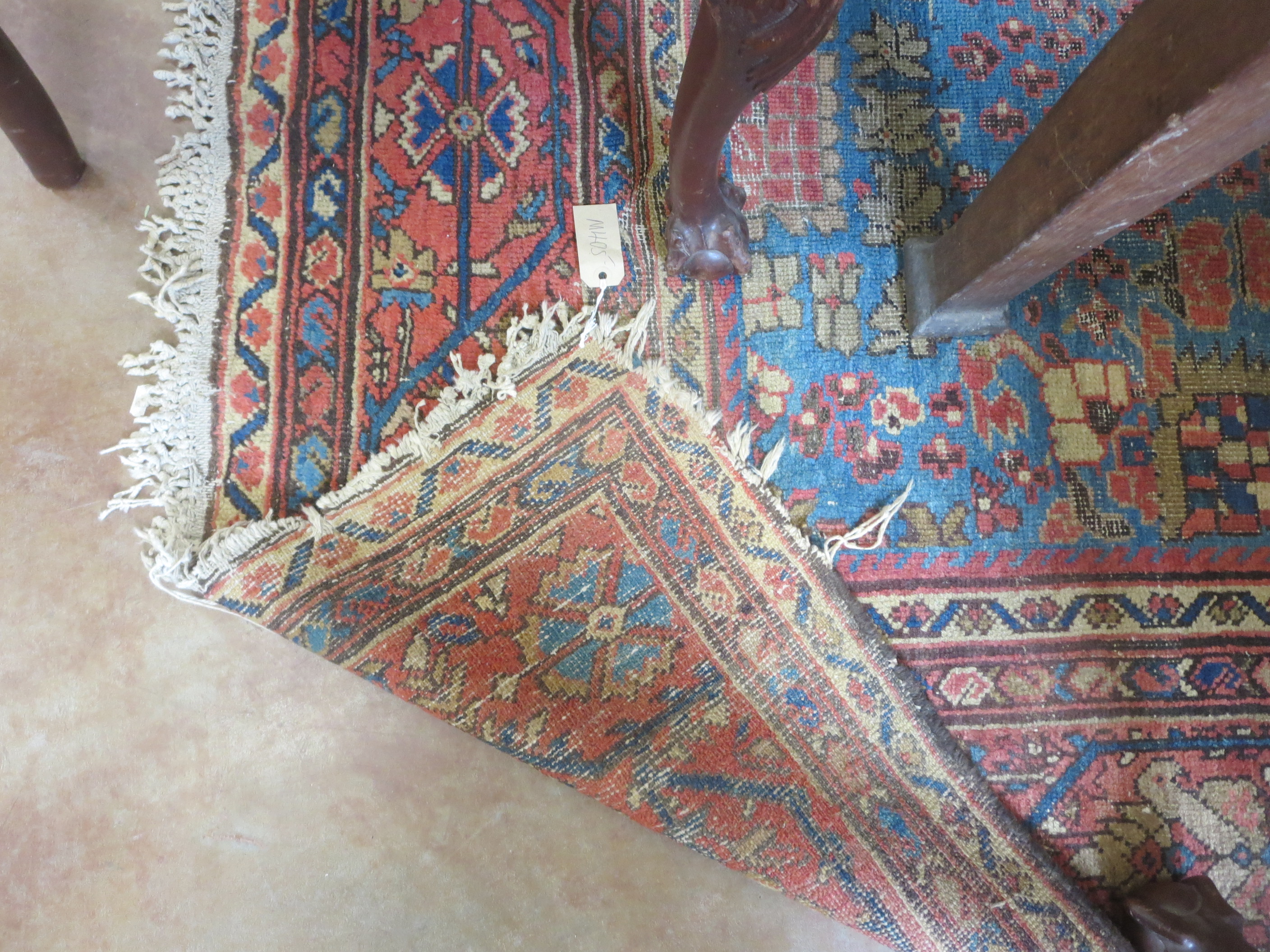 An old bordered Persian Carpet with red stylised motifs on a blue ground, principal border with - Image 6 of 8