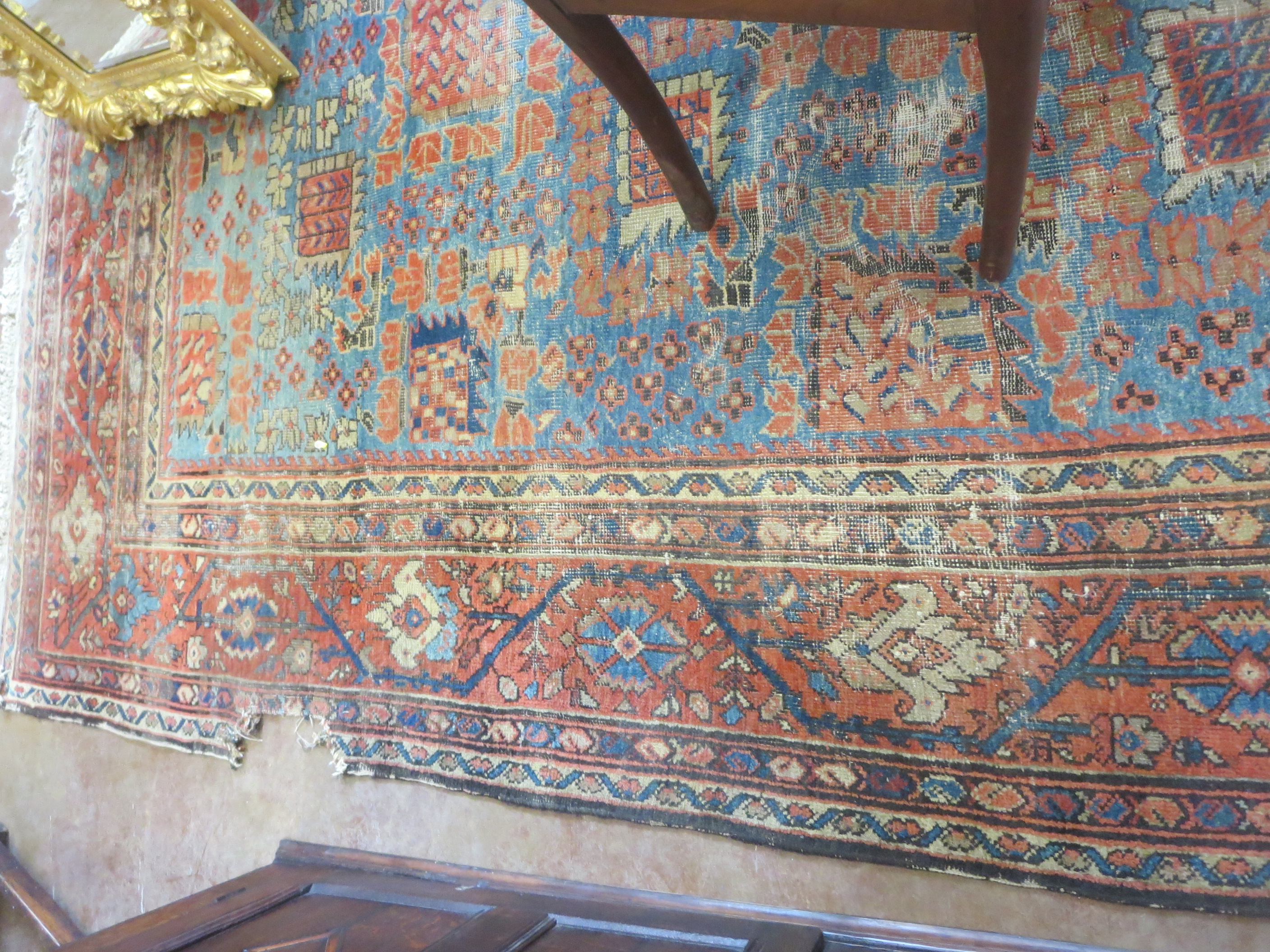 An old bordered Persian Carpet with red stylised motifs on a blue ground, principal border with - Image 3 of 8