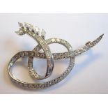 A Diamond Ribbon Brooch pavé-set brilliant-cut stones terminating in a row of channel-set