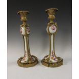 A pair of porcelain Candlesticks, painted floral designs, mounted in ormolu with moulded edges and