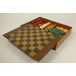 A 19th Century wooden Games Box with sliding cover and containing items for various games