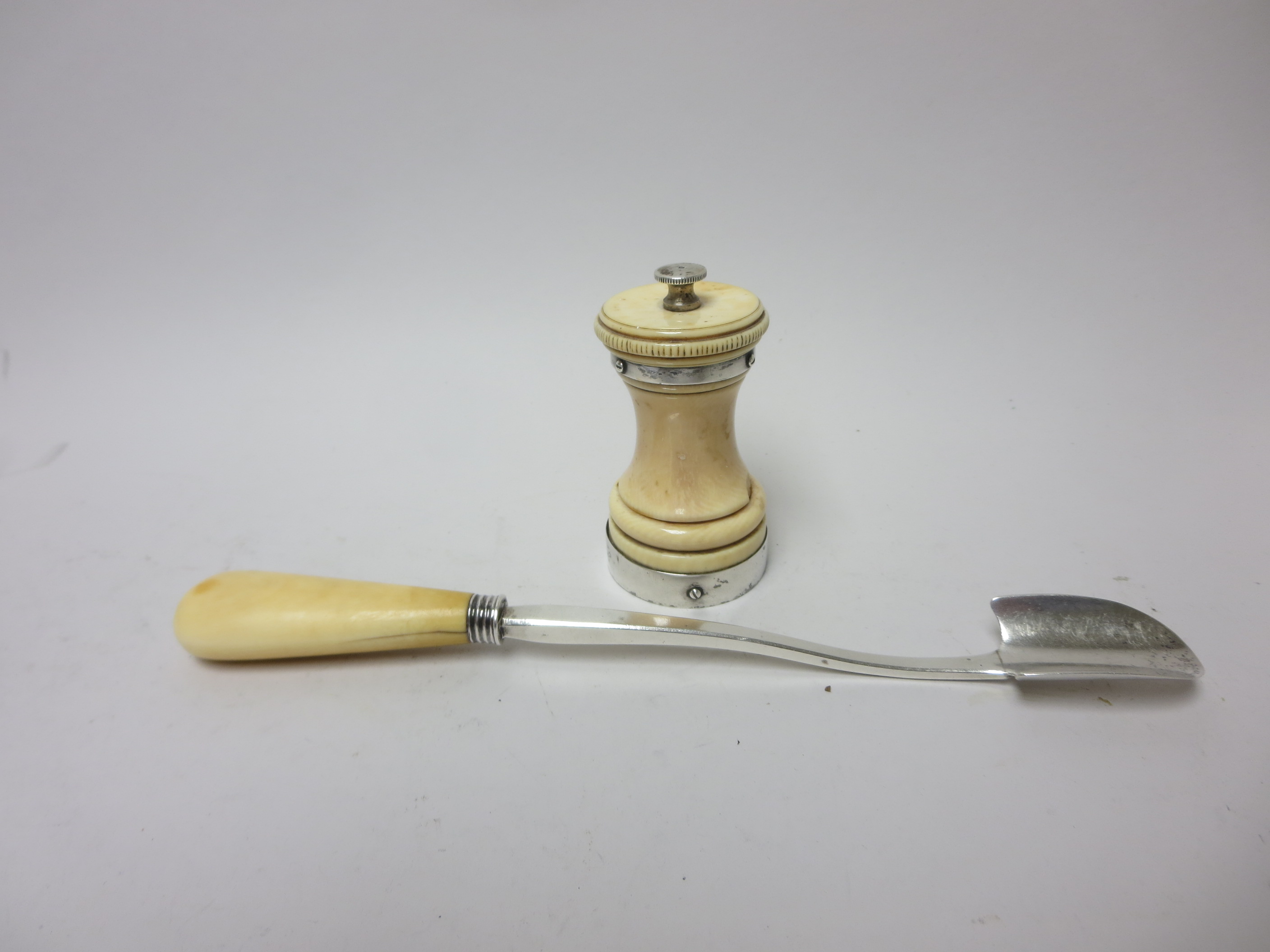 A George III Stilton Scoop with baluster ivory handle. London 1804, and a silver mounted Pepper