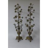 A pair of tall French brass Candle Stands, each with seven sconces, and having flower and leaf