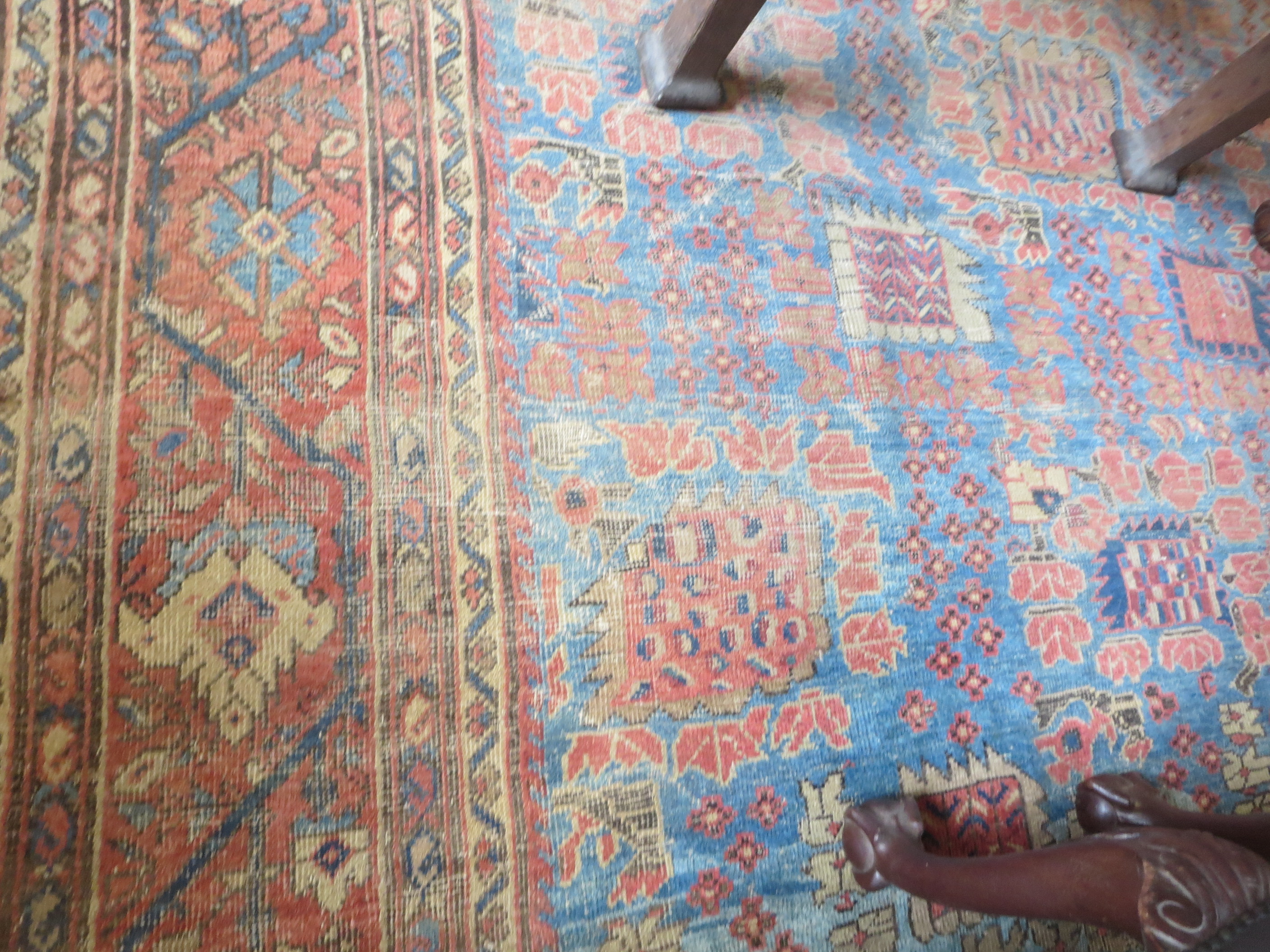 An old bordered Persian Carpet with red stylised motifs on a blue ground, principal border with - Image 4 of 8