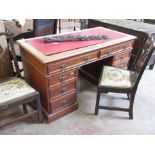 A 19th Century walnut Writing Desk with leather inset top fitted two drawers above two pedestals