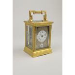 A 19th Century brass cased French Carriage Clock, with white enamelled dials having blue detail,