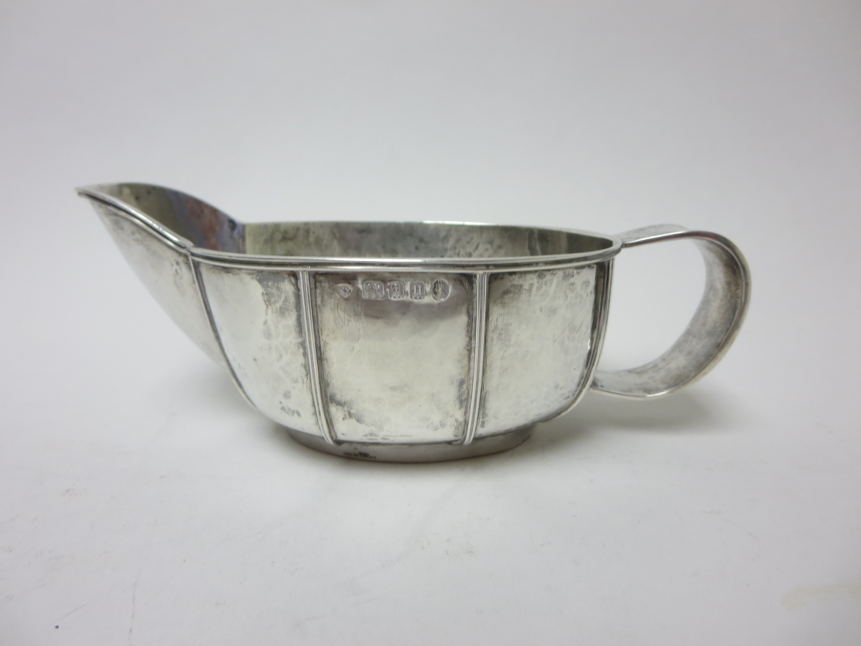 A George V silver Sauce Boat with Arts & Crafts hammered and ribbed design, London 1935 maker: AS