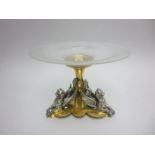 A brass and white metal Centre Piece with engraved glass surmount on three griffin supports, 8 1/