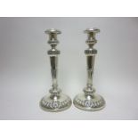 A pair of George IV silver Candlesticks with tapering columns on circular bases with gadroon frieze,
