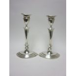 A pair of Edward VII silver Candlesticks with tapering columns on oval bases, London 1903/4, 9 1/