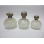 Three silver lidded cut glass Scent Bottles, a modern shaped circular Salver and a reeded oval Dish