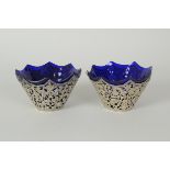 A pair of Victorian silver Sweetmeat Dishes with blue glass liners, having pierced design of cherubs