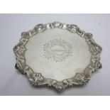 A George II silver shaped circular Salver with engraved cartouche, shaped border on hoof feet,