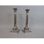 A pair of Elkington & Co. plated Candlesticks with corinthian columns, ram's head mounts and swags